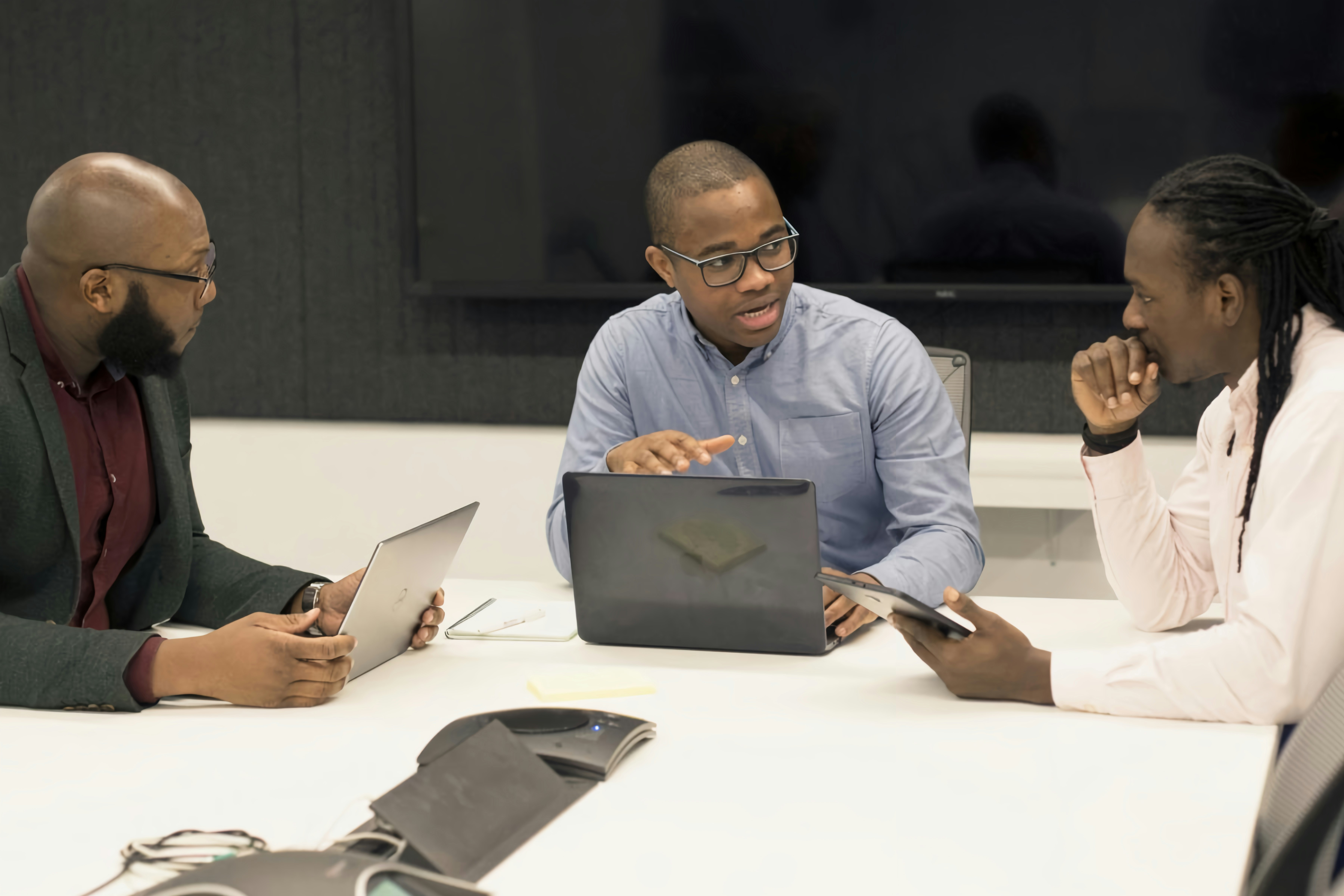 Legal professionals discussing a matter with technology tools